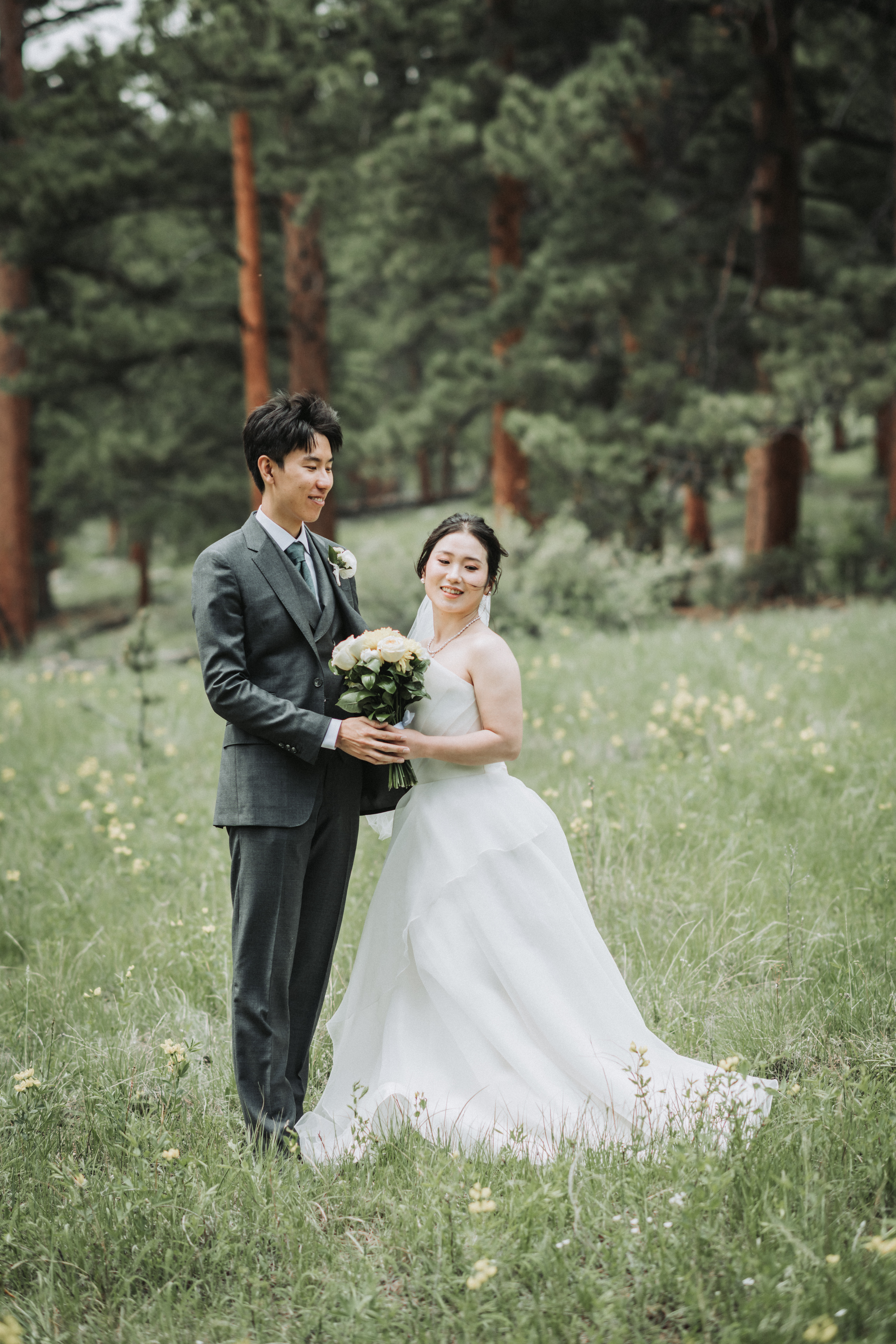 Bride in her wedding gown at a window